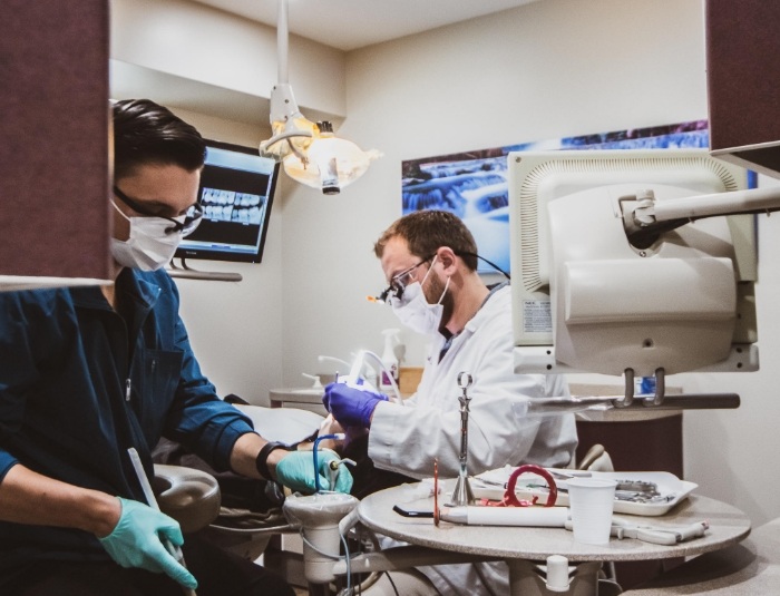Doctor Rodda and dental assistant treating a dental patient in Phoenix