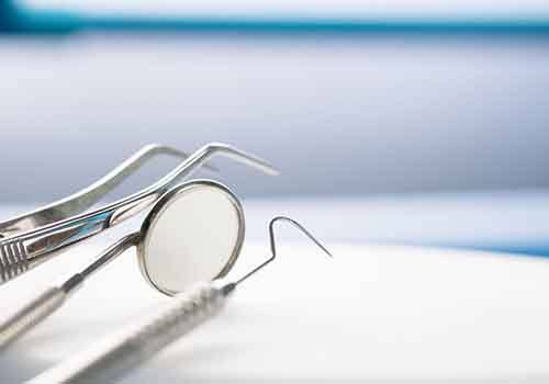 Dental instruments on white table