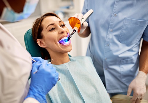 A woman undergoing a tooth-colored fillings treatment